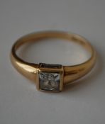 A hallmarked 9ct gold ring set with a cushion cut white stone.  Hallmarked London. Size  Q.5. Weight