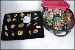 A case of vintage costume dress jewellery along with a group of 20 brooches to include