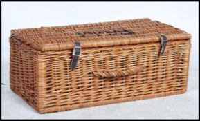 A vintage 20th century Fortnum and Mason wicker basket picnic hamper with stencilled lettering.