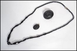A group of mourning jewellery dating from the 19th century to include a carved jet cameo brooch ,