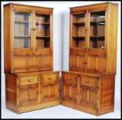 Ercol - Mural -  A pair of glazed window bookcases comprising of a twin glazed bookcase top with a