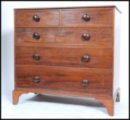 An early 19th century Georgian mahogany chest of drawers raised on bracket feet. The bank of two