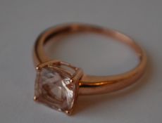 A hallmarked 9ct rose gold ring set with a cushion cut morganite.  Hallmarked Birmingham.  Size