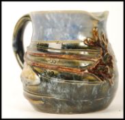 A Royal Doulton stoneware creamer milk jug, the design attributed to George Tinworth, the body