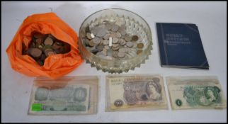 A collection of assorted coins together with vintage bank notes