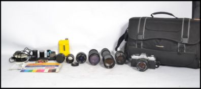 A vintage 20th century Minolta X - 500 35mm camera and accessories to include several lenses and a