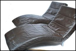 A pair of contemporary chaise longue day beds of shaped form being tubular legs finished in brown