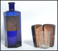 A 19th century blue glass apothecary hexagonal poison bottle along with a cased Chemist measure.