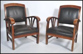 A pair of French art deco style solid hadrwood carver fireside armchairs having a square backrest
