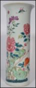 A 19th century Chinese famille rose vase. The tall cylindrical vase hand painted with floral