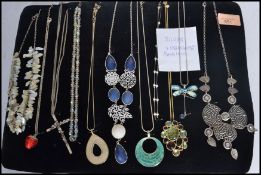 A group of 9 silver and costume jewellery necklaces to include mother of pearl , tribal ,