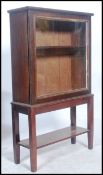 A Victorian oak display cabinet on stand. The stand having square tapered legs with lower tier.
