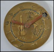 An unusual 20th century Rock Around The Clock calendar of circular form depicting musical