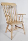 A Victorian style 20th century light beech wood windsor armchair - chair. Raised on turned legs