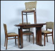 A 1930's Art Deco dark walnut draw leaf dining table together with a matching set of 4 dining