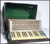 A vintage 20th century Carlos Carsini accordion musical instrument complete in original case.