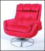 A 20th Century retro Danish inspired red upholstered swivel easy lounge chair, having tubular chrome