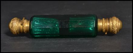 A 19th century Victorian faceted green glass double ended perfume bottle with hinged gilt metal