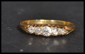An 18 carat gold three stone diamond ring. Weighs 2.5 grams size R.