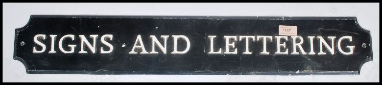 A vintage 20th century metal wall / advertising sign with notation ' Signs & Lettering ' Black