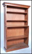 A good early 20th century Edwardian pitch pine country open bookcase having a series of adjustable