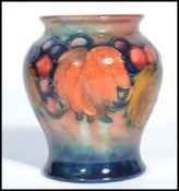 An early 20th century William Moorcroft for Moorcroft small squat vase hand painted and tube lined
