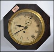 A vintage early 20th century bulkhead clock having a wooden back. The silvered dial having faceted