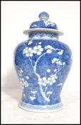 An early 20th century Chinese blue and white ceramic lidded vase decorated in the prunus pattern