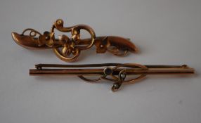 Two early 20th century 9ct gold pin brooches one having interwoven foliates the other being set with
