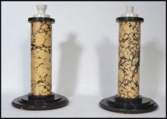 A pair of 20th century electric faux marble matching table lamps the faux marble columns raised on