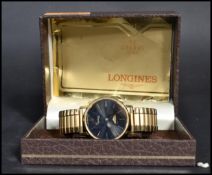 A vintage Longines quartz movement wrist watch complete in the original box. The black enamel face
