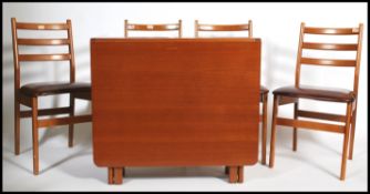A 1970's retro teak wood drop leaf dining table together with a set of 4 matching teak dining chairs