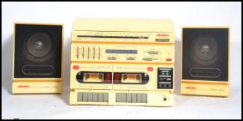 A vintage Bush Radio 1980's white / cream hi-fi stereo system having hinged top record player, radio