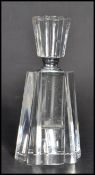 A vintage Art Deco faceted glass perfume bottle having a rounded octagonal body and stopper.