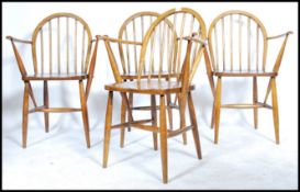 A set of four Ercol mid 20th century carver hoop back chairs having spindle backs with CC41