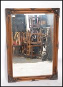 A large 20th century antique style bevelled edge overmantel mirror having a rectangular frame with