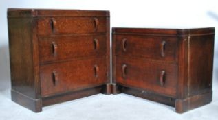 A matched pair of 1940's oak utility furniture chests of drawers having shaped handles together with