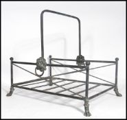 A vintage 20th century antique style copper log basket having lion masks raised on hairy paw feet.