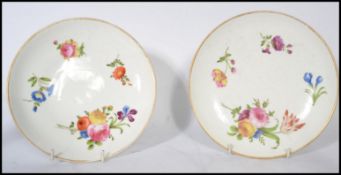 A pair of 19th century ceramic cabinet plates hand painted with floral sprays raised on a circular
