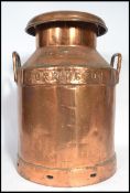 A vintage early 20th century copper dairy milk churn having handles to sides. With notation for