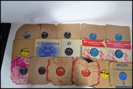 A collection of 78rpm records to include Elvis Teddy Bear, Blue Suede Shoes, Don't Be Cruel, Blue