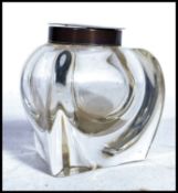 A silver hallmarked glass desk top inkwell of unusual bulbous glass form having silver collar and