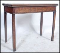 A 19th century Georgian mahogany card - games / tea table being raised on squared legs having a