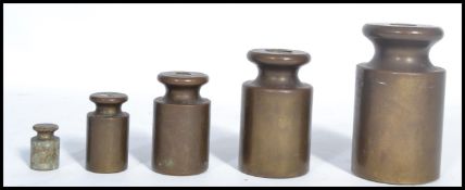 A group of five 19th century Victorian bronze graduating bell weights, Stamped Avery. Highest