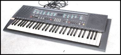 A 1990's Yamaha PSR200 electronic keyboard complete in the original box.