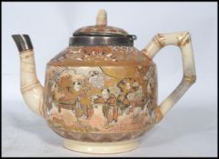 A 19th century Oriental Japanese teapot decorated with traditional scenes having a Victorian