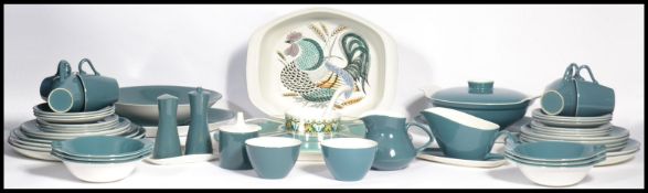 A mid century Poole dinner and tea service in a light blue colourway including a lazy Susan.