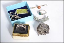A group of vintage costume jewellery to include a Cleopatra style brooch, silver earrings with