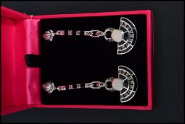 A pair of sterling silver marcasite onyx and opal set art deco style drop earrings having axe