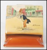 A 20th century Royal Doulton Pickwick match box holder match strike depicting Mr Pickwick and Mr